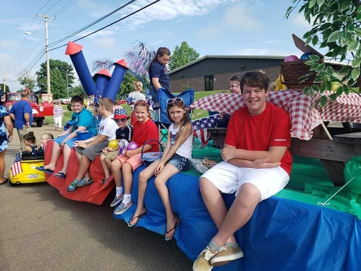 Children who are residents of White Pine, TN, sitting on a parade float
