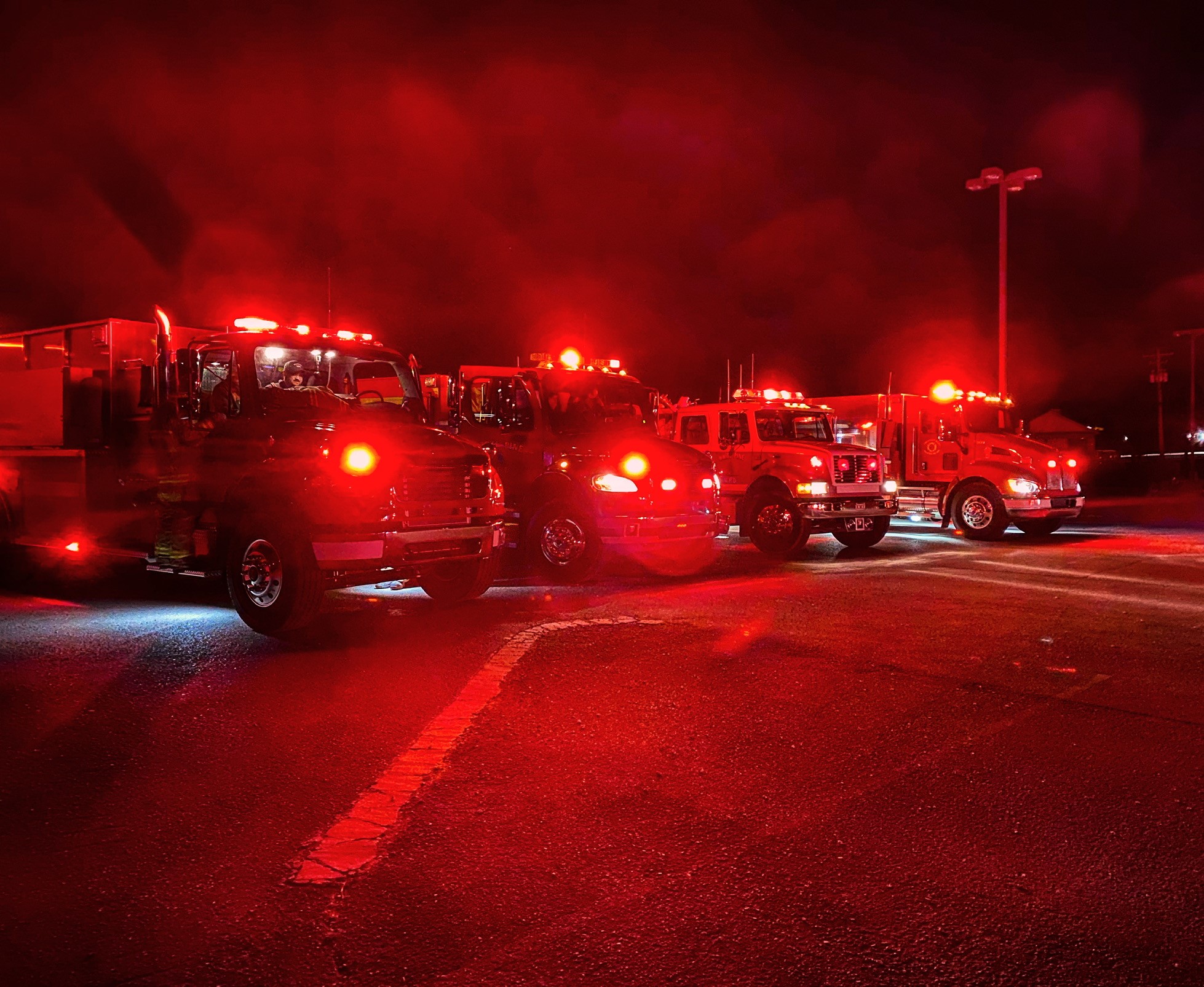 white pine fire department trucks with lights on at night