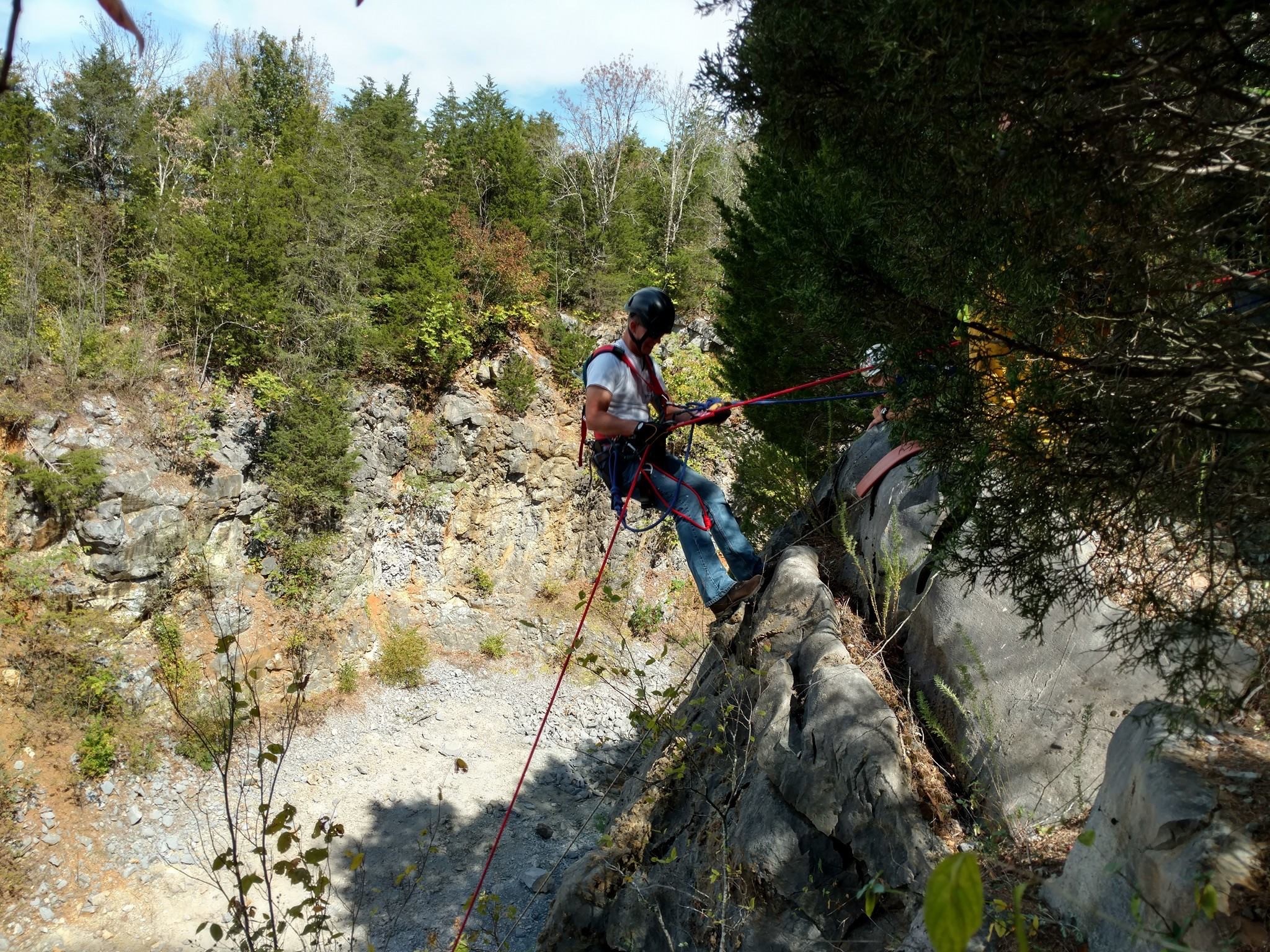 white pine fire department fire fighter repelling down a side of a cliff